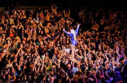 Peaches in Toronto concert. Crowd surfing at a Peaches concert in Toronto. Gay travel guide. Toronto travel advice.