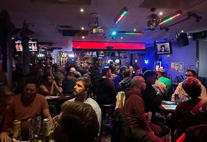 Pegasus on Church gay bar in Toronto. A lively, crowded scene of gay men enjoying drinks and socializing in a dimly lit space.