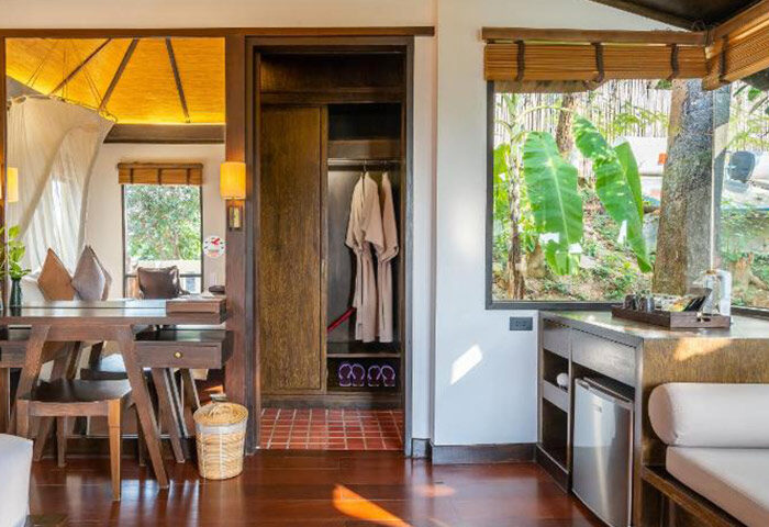 Le Vimarn Cottages & Spa interior. Beachfront gay hotel in Koh Samet. Perfect for Mr and Mr travel. Closet, desk, and tropical view.