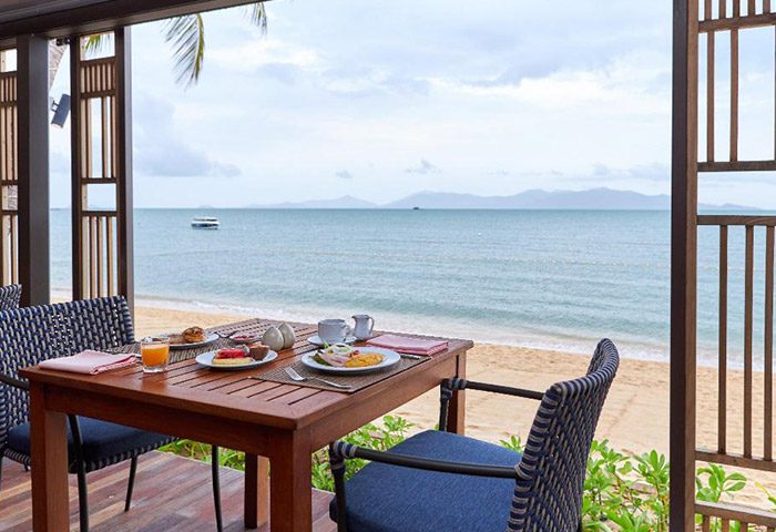 Beachfront dining at Bandara Resort & Spa, Koh Samui. Perfect pool villas view. Gay-friendly hotel breakfast with ocean view.