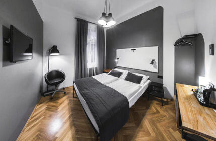 Czech Inn: Perfect double beds in a gay hostel in Prague's Vinohrady. Modern room interior, ideal for gay couples' travel.