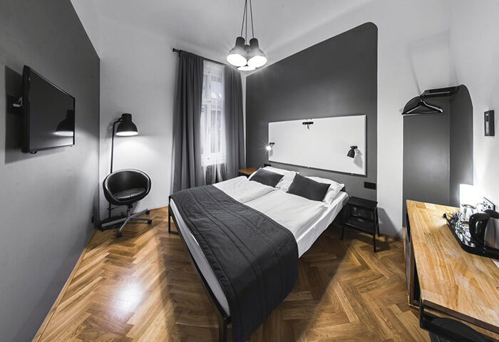 Czech Inn: Perfect double beds in a gay hostel in Prague's Vinohrady. Modern room interior, ideal for gay couples' travel.