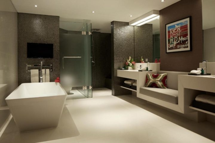 Double-Six Luxury Hotel Seminyak bathroom. Modern design with tub, shower, and vanity. Perfect for a gay beach honeymoon in Bali.