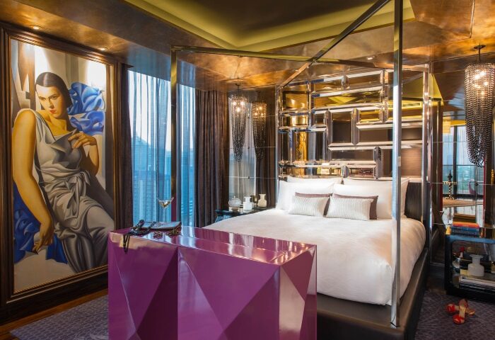 Bangkok Hotel Indigo Wireless Road: Gay honeymoon suite with a four-poster bed, modern art, & cityscape views. Perfect for a romantic getaway.