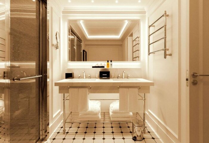 Sofitel Barcelona Skipper's bathroom. Perfect gay honeymoon hotel near Mar Bella gay beach. Double sink, shower, and illuminated mirror.