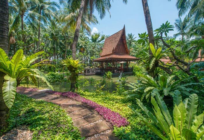 Avani Pattaya Resort garden gazebo, perfect for a gay honeymoon. Lush tropical foliage surrounds a pond at this Pattaya hotel.