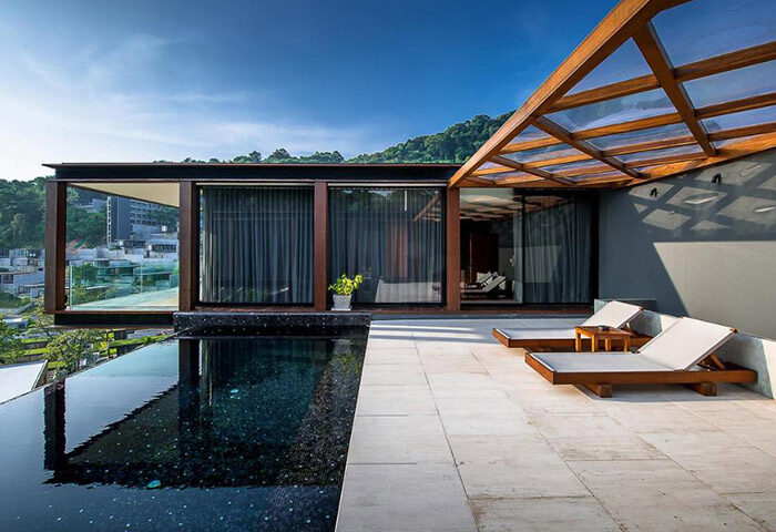 The Naka Phuket Villa's private beachfront pool villas, perfect for a gay honeymoon. Features a modern design and luxurious outdoor space.