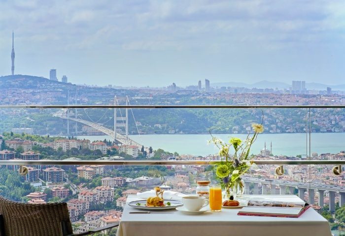 Breakfast with a view at Raffles Istanbul Hotel, perfect for a gay honeymoon. Overlooking the Bosphorus, a luxury gay travel experience.