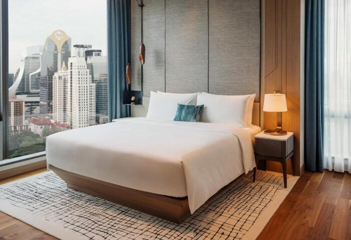 Kimpton Maa-Lai Bangkok hotel room. Perfect for a gay honeymoon, luxurious bed, city view. One of Bangkok's best gay-friendly hotels.
