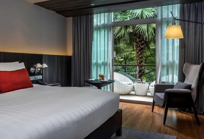 Pullman Bangkok King Power hotel room with balcony. Perfect gay honeymoon hotels in Bangkok. Modern design with nature view.
