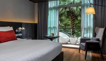 Pullman Bangkok King Power hotel room with balcony. Perfect gay honeymoon hotels in Bangkok. Modern design with nature view.