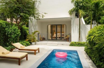The Standard, Hua Hin: A perfect gay honeymoon hotel. Pool with pink float, sun loungers, and private patio. Ideal for gay couples' retreats.
