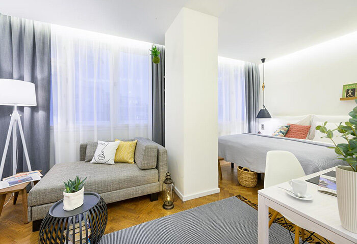 Mosaic House Design Hotel, Prague. A perfect gay honeymoon hotel in Prague's Old Town. Modern room interior with bed and couch.
