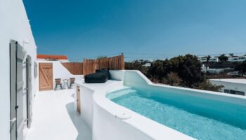 Akkadian Gay Hotel Mykonos pool villa. Perfect gay honeymoon spot with private pool, white architecture, and sunny skies. Gay-only luxury travel.