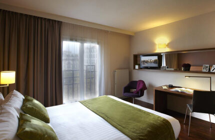 Citadines Les Halles Paris room. Gay-friendly hotel near gay bars, cruise clubs. Comfortable bed, desk, TV, chair. Perfect for gay travelers.