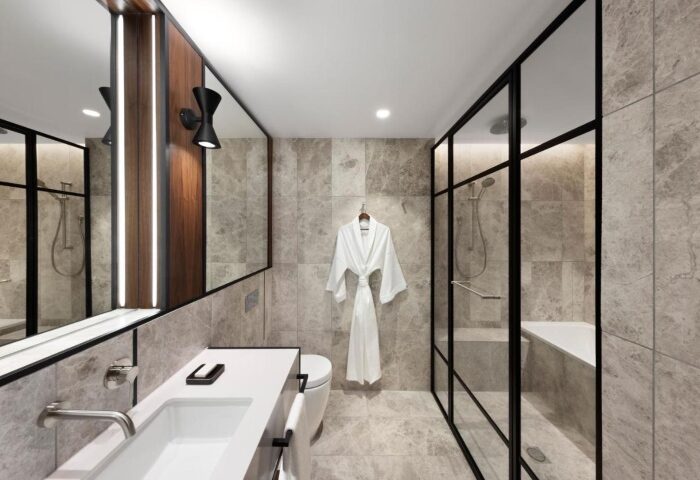 Le Meridien Melbourne's stylish bathroom. Gay-friendly hotel near Collingwood's gay bars/clubs. Features modern design, shower, and robe.