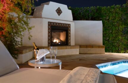The Hacienda at Warm Sands, a gay resort in Palm Springs. Champagne, fireplace, and pool create a romantic, luxurious ambiance.
