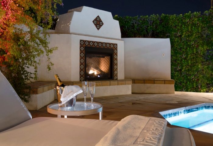 The Hacienda at Warm Sands, a gay resort in Palm Springs. Champagne, fireplace, and pool create a romantic, luxurious ambiance.