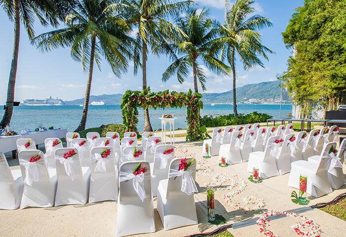 Amari Phuket beachfront gay wedding venue. Chairs, floral arch, and ocean view create a romantic setting in Thailand. Perfect for destination weddings.