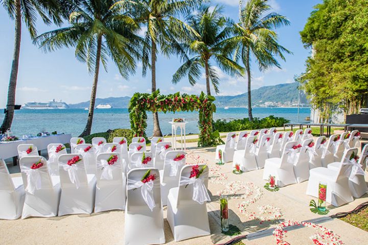 Amari Phuket beachfront gay wedding venue. Chairs, floral arch, and ocean view create a romantic setting in Thailand. Perfect for destination weddings.