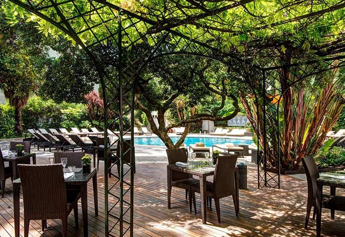 Tivoli Avenida Liberdade: Gay hotel in Lisbon's gayborhood. Outdoor dining area by the pool, perfect for a honeymoon. Leading Hotels of the World.