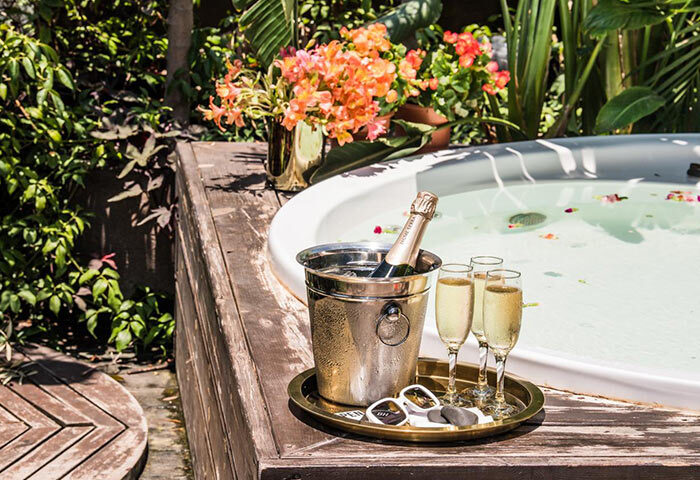 Brown TLV Hotel: Honeymoon inspiration for gay couples in Tel Aviv. Champagne, glasses, and a jacuzzi for a romantic getaway.