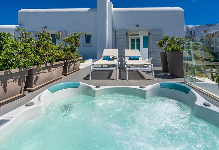 Semeli Hotel Mykonos pool view. Perfect hotel for a group of six people in Mykonos Town gayborhood. Hot tub and lounge chairs on private patio.