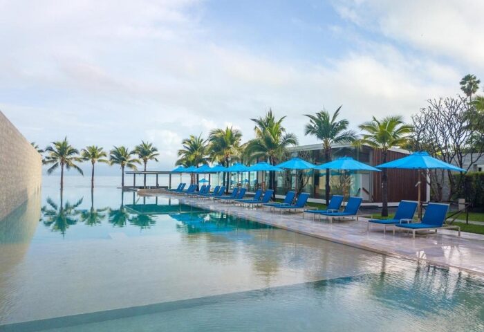 Explorar Koh Samui adults-only resort beachfront hotel pool view. Perfect Instagram spot for gay travelers. Relaxing vacation vibes.