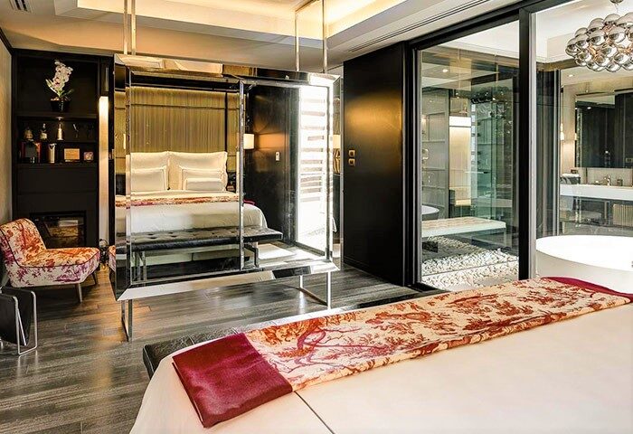 Akyra Manor Chiang Mai hotel room, perfect location for gay travelers. Luxury suite with mirrored bed frame and modern bathroom. Thailand gay travel.