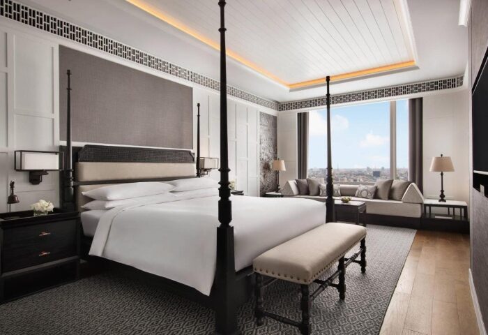 Luxury hotel room at Bangkok Marriott Surawongse, perfect for gay honeymoon couples. Four-poster bed, city view. A top choice for gay travel.