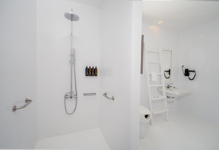 Akkadian Hotel Mykonos gay only hotel bathroom. Modern shower and toilet in a perfect pool villa for gay men's travel advice.