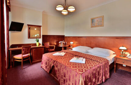 Hotel Arkada Praha room. Perfect weekend getaway in Prague's gayborhood, Vinohrady. Double bed, desk, TV, & sitting area.