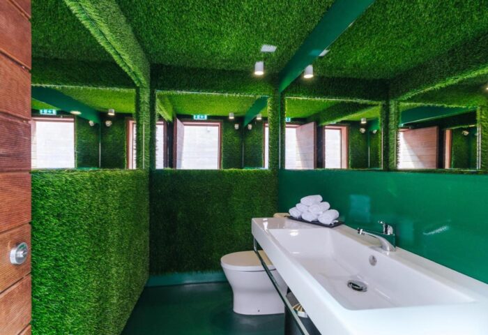 Pestana CR7 gay-friendly hotel Madeira: Bathroom with artificial grass on walls and ceiling. Modern sink and toilet. Unique design.