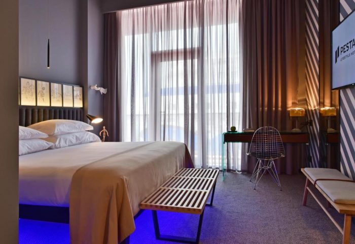 Pestana CR7 gay-friendly hotel room. Stylish bedroom with a bed, desk, and modern decor. A great choice for gay men's travel.