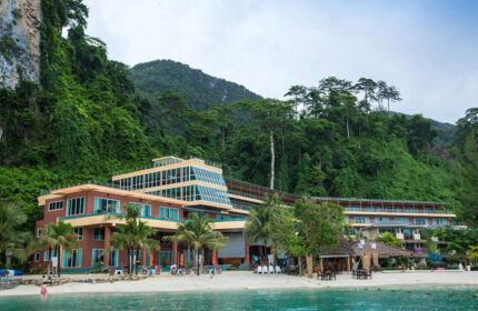 Phi Phi Cliff Beach Resort, a beachfront gay hotel. View of the resort's architecture and beach. Great for gay travel and rooftop pool.