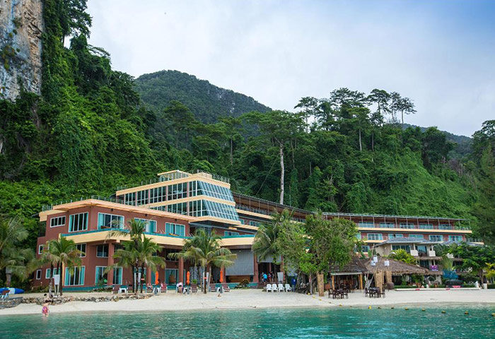 Phi Phi Cliff Beach Resort, a beachfront gay hotel. View of the resort's architecture and beach. Great for gay travel and rooftop pool.