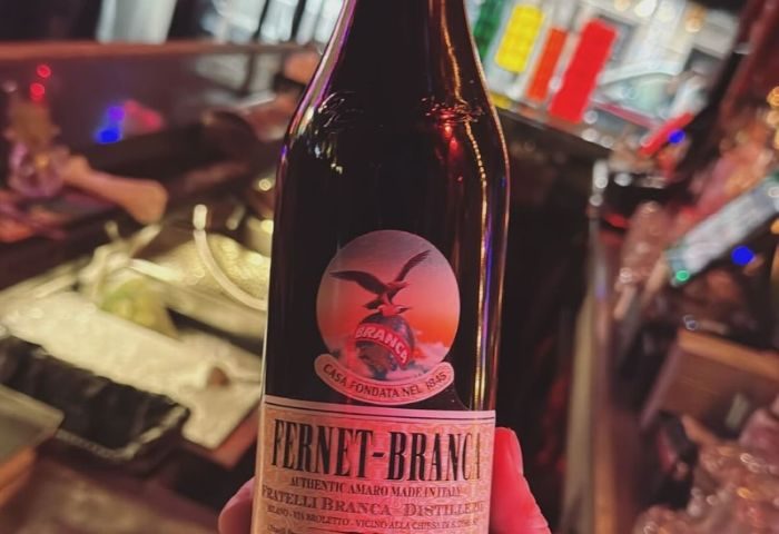 Pieces Bar in New York: Fernet-Branca bottle. Popular drink at gay bar. Travel advice for gay men. Nightlife in NYC.