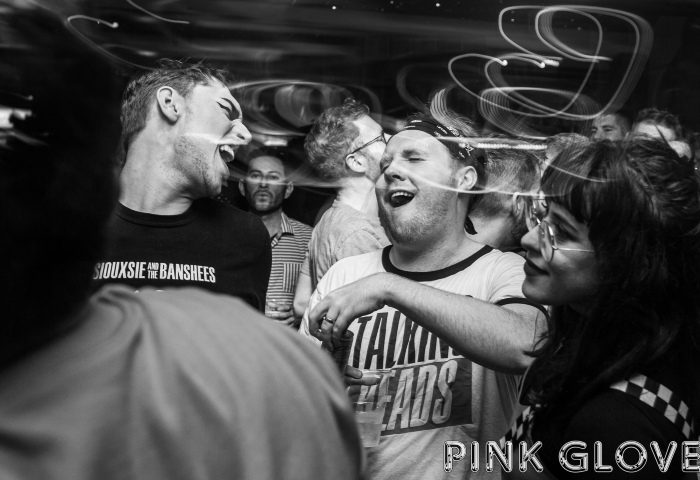 Black and white shot of Pink Glove, London's best queer party in Bethnal Green Working Mens Club. People dancing and having fun.