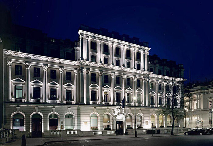 Sofitel St James London Hotel, a popular gay-friendly spot for parties. The building's facade is illuminated at night, showcasing its architecture.