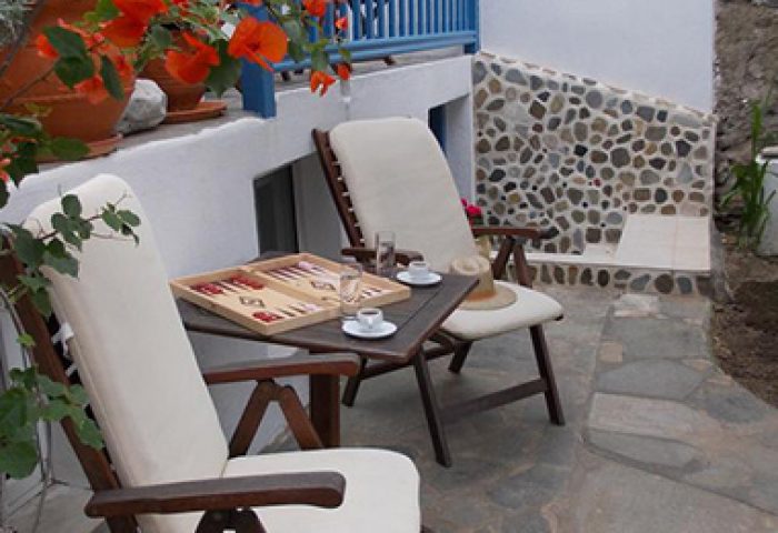Matina Hotel's private balcony: Gay travelers' choice. Chairs, table with backgammon, coffee, and flowers. Ideal gay hotel for relaxing.