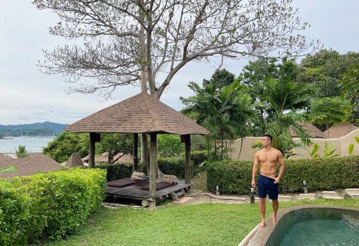 Gay Phuket Hotel: Man at The Naka Island Luxury Resort & Spa pool villa. Honeymoon destination with spa, gazebo, and ocean view.
