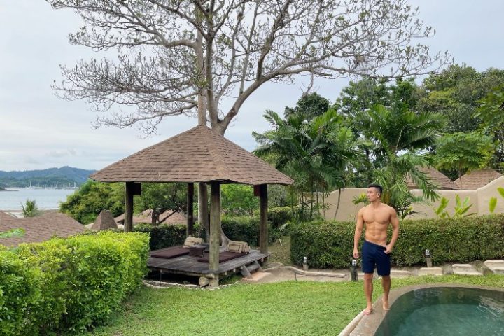 Gay Phuket Hotel: Man at The Naka Island Luxury Resort & Spa pool villa. Honeymoon destination with spa, gazebo, and ocean view.