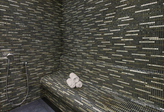 JW Marriott Hotel Istanbul Marmara Sea hamam. Mosaic tiled steam room with towels and shower. Luxury beachfront hotel near gay hamams.