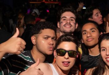 Gay men at Posh Club Lisbon, a popular gay nightlife destination. Group selfie, thumbs up, and party vibes. Lisbon gay travel.