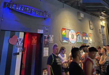 Powerhouse Gay Bar in San Francisco. Patrons outside the Powerhouse, a popular gay bar. LOADS mural on the wall. Nightlife scene.