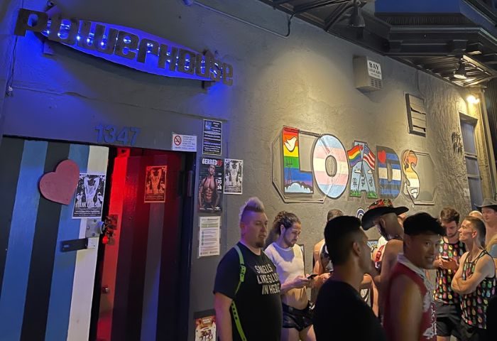 Powerhouse Gay Bar in San Francisco. Patrons outside the Powerhouse, a popular gay bar. LOADS mural on the wall. Nightlife scene.