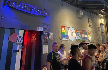 Powerhouse Gay Bar in San Francisco. Patrons outside the Powerhouse, a popular gay bar. LOADS mural on the wall. Nightlife scene.