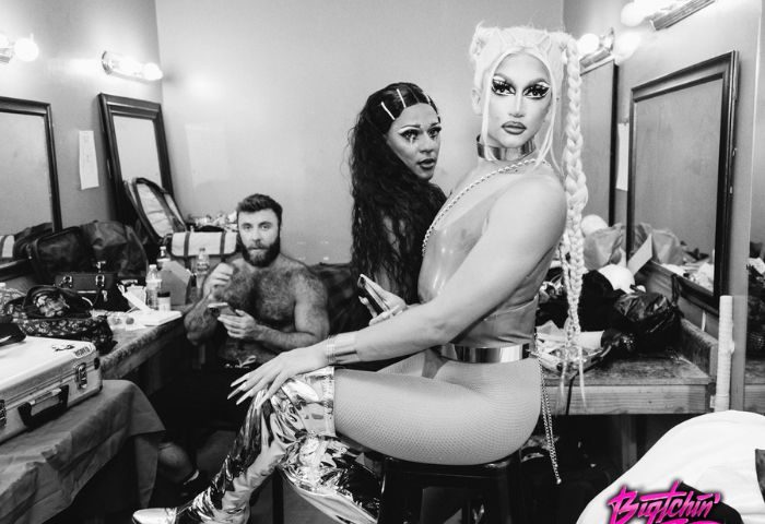 Precinct Drag: Black and white shot of drag queens and a shirtless man in a dressing room. Gay nightlife and travel advice.