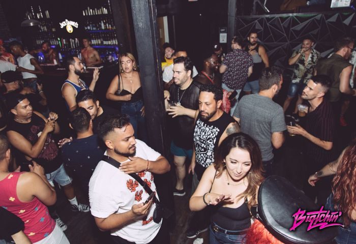 Precinct Location: Gay men dancing at a crowded gay bar. Nightlife scene with diverse group, bar, and drinks. Gay travel advice.