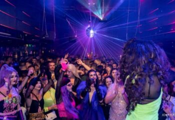 Packed Prima s-Bar gay bar in Madrid with drag queens, laser lights, and disco ball. Gay nightlife travel advice.
